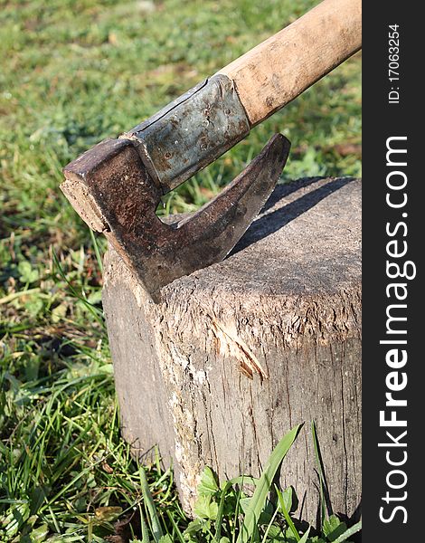 Well used axe in old used stump. Well used axe in old used stump