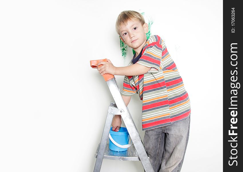 Young boy painting over white