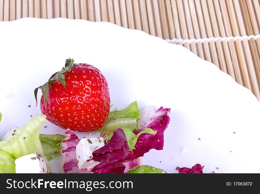 Strawberry and salad on plate