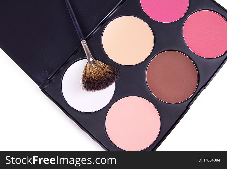 Professional make-up brush on eyeshadows palette, closed-up