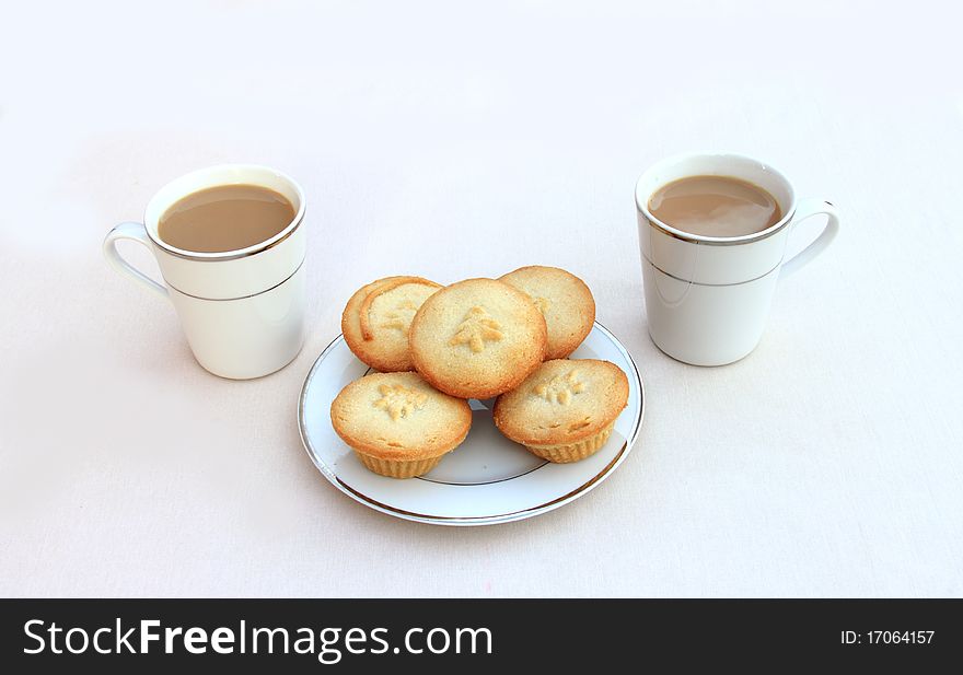 Two coffees with a plate of mince pies. Two coffees with a plate of mince pies