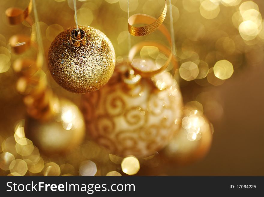 Golden christmas balls on bokeh background