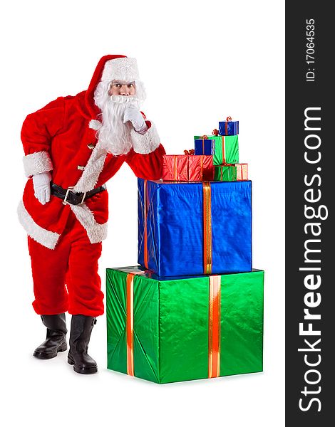 Serious and thoughtful Santa Claus standing, leaning on a box with gifts. Isolated on white. Serious and thoughtful Santa Claus standing, leaning on a box with gifts. Isolated on white.