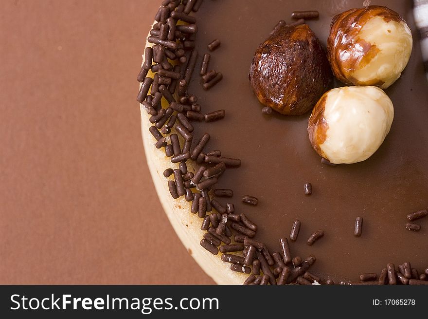 Chocolate tart with sprinkles close up