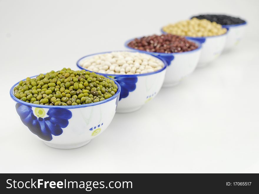 Colorful beans in white china bowls.