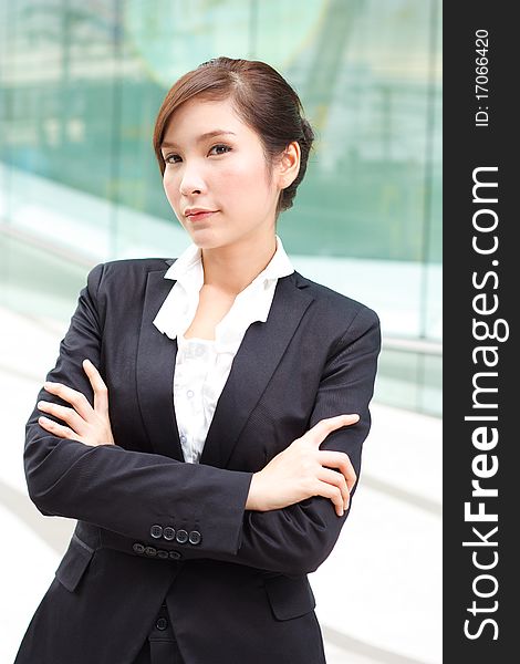 Young attractive businesslady in front of business building. Young attractive businesslady in front of business building