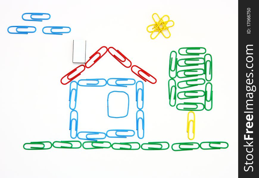 The house and tree from color paper clips on a white background with clouds and the sun. The house and tree from color paper clips on a white background with clouds and the sun