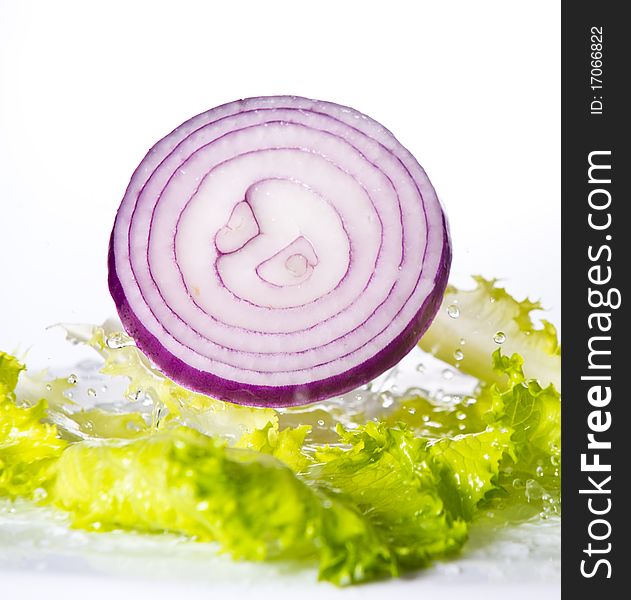 Onion falling into a salad