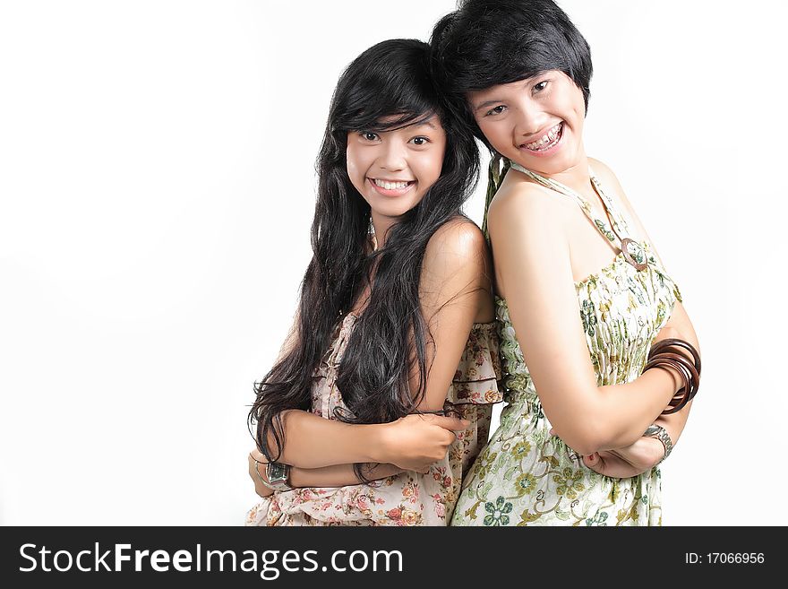 Two girl best friends smiling over white background