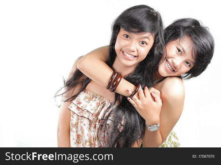 Two girl best friends smiling over white background
