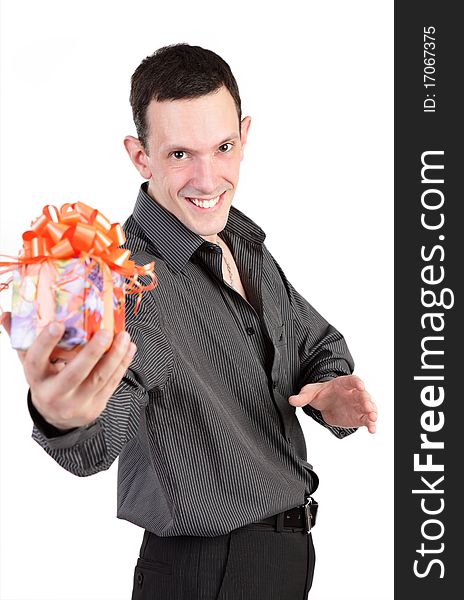 The young smiling guy in a black shirt gives a gift. The young smiling guy in a black shirt gives a gift