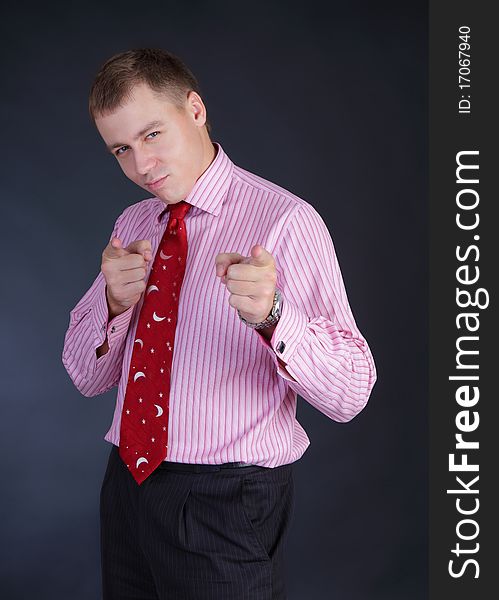 Slender beautiful young fellow in a shirt with a tie in a studio. Slender beautiful young fellow in a shirt with a tie in a studio