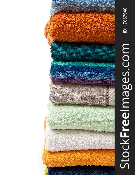 Pile of bright color towels isolated on withe background. Pile of bright color towels isolated on withe background