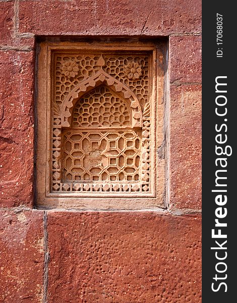 Old ornament on the decorative stone window on the wall. Old ornament on the decorative stone window on the wall