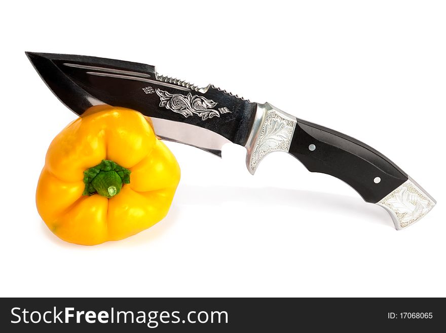 The big knife cuts pepper isolated on a white background. The big knife cuts pepper isolated on a white background