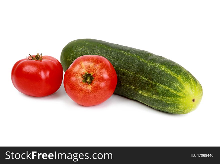 fresh tomatoes and cucumber on the white background. fresh tomatoes and cucumber on the white background