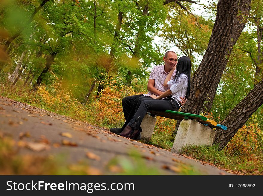Young lovely couple sitting in the park