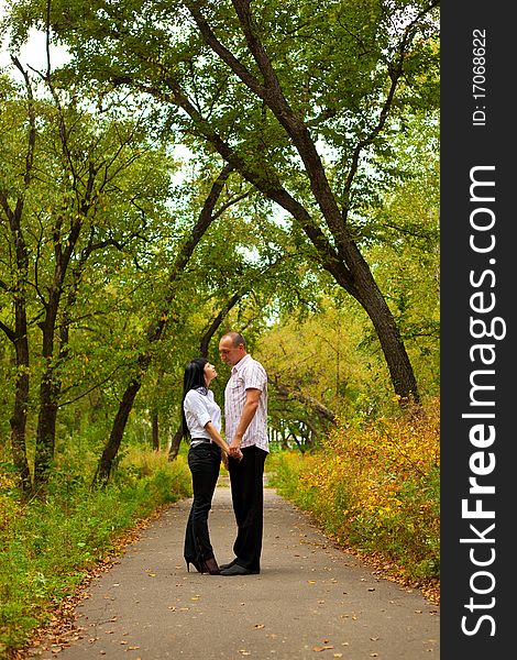 Young lovely couple walking in the park