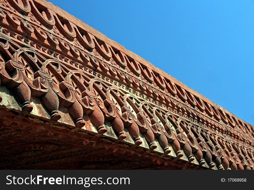 Architecture of India. The pattern on a red stone. Architecture of India. The pattern on a red stone.