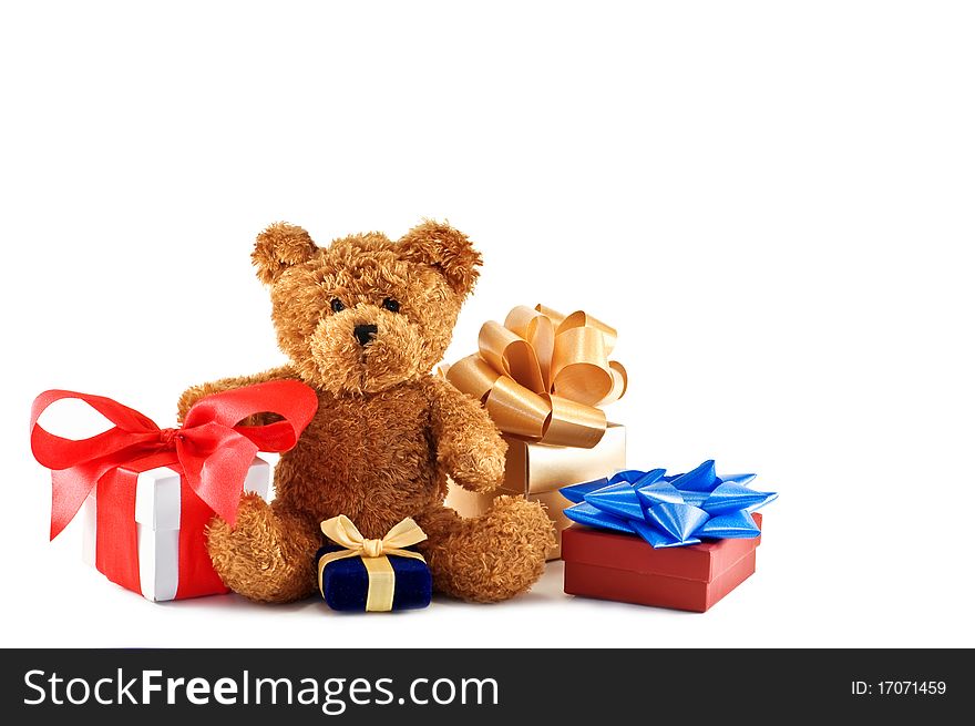 Teddy bear with presents isolated