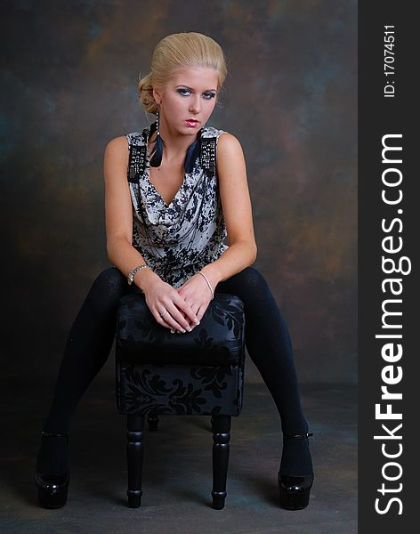 Photograph showing beautiful young woman sat on lounger. Photograph showing beautiful young woman sat on lounger