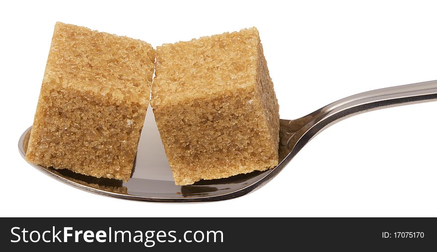 Cube of brown sugar on spoon, isolated on white with clipping path