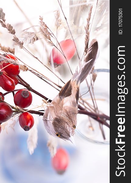 Bouquet of autumn berries and little bird toy. Bouquet of autumn berries and little bird toy