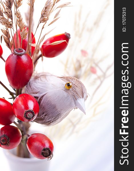 Autumn berries and toy bird