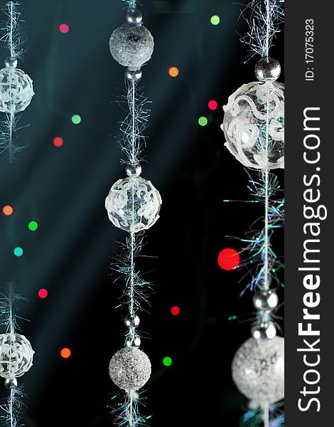 Silver christmas balls with a colorful lights on the black background. Silver christmas balls with a colorful lights on the black background