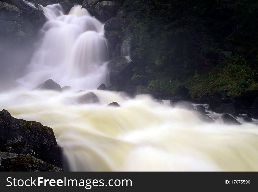 Big waterfall in mountain. Beautiful Flowing water