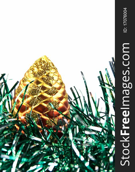 Detail of a pine christmas decoration on green tinsel