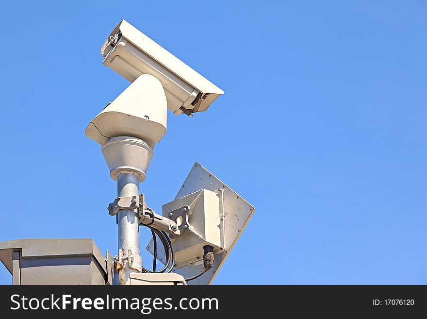 Closeup of isolated Surveillance Security Camera or CCTV on blue sky