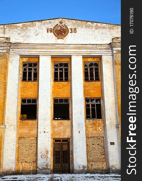 Abandoned army barracks against the blue sky