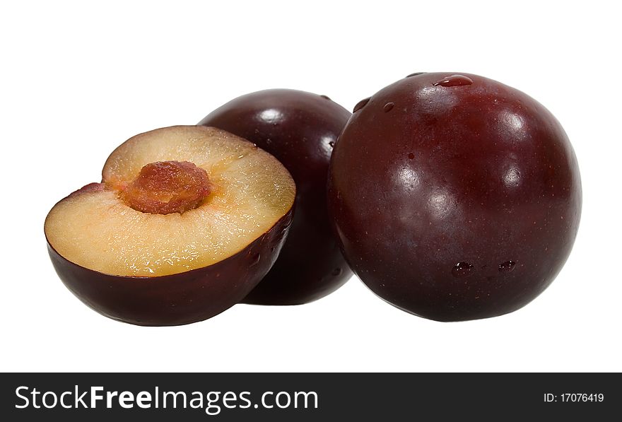 Three plums with pulp and stone