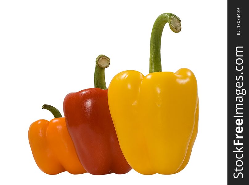 Green, red, orange peppers isolated on the white background. Green, red, orange peppers isolated on the white background