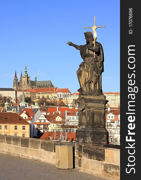 Baroque Statue on the Prague Charles Bridge with beautiful Castle. Baroque Statue on the Prague Charles Bridge with beautiful Castle