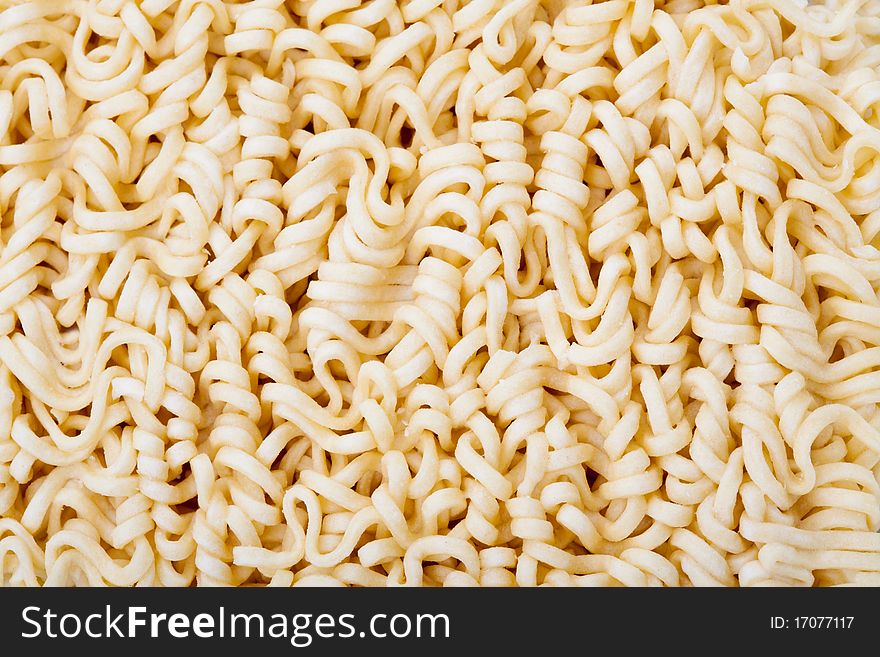 Macro shot of dried noodles. Suitable for concepts such as diet and nutrition, textures and backgrounds, and food and beverage.