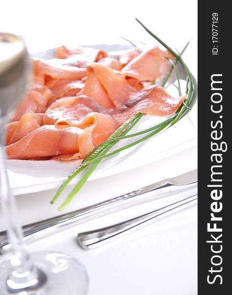 Smoked salmon with chives an a white table. Smoked salmon with chives an a white table