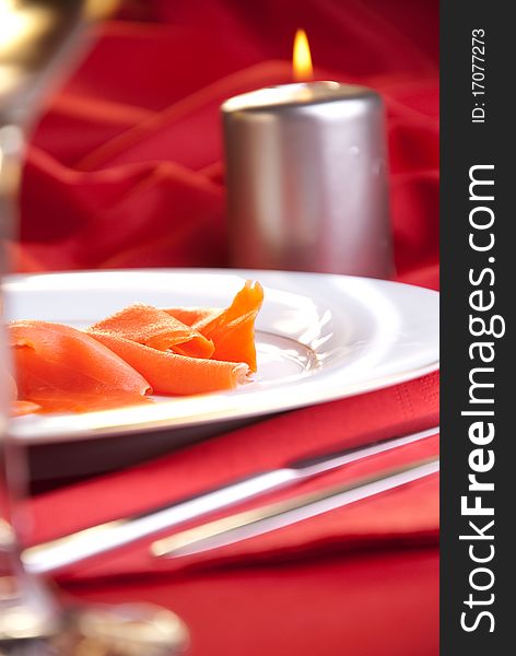 Smoked salmon with chives for Christmas, on a red-decorated table. Smoked salmon with chives for Christmas, on a red-decorated table