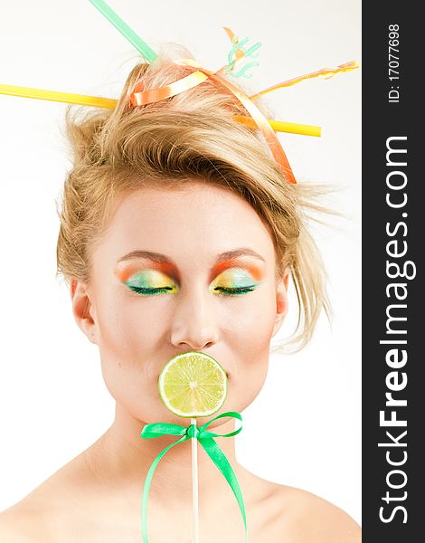 Beauty girl close one's mouth piece of lime on a stick. Beauty girl close one's mouth piece of lime on a stick