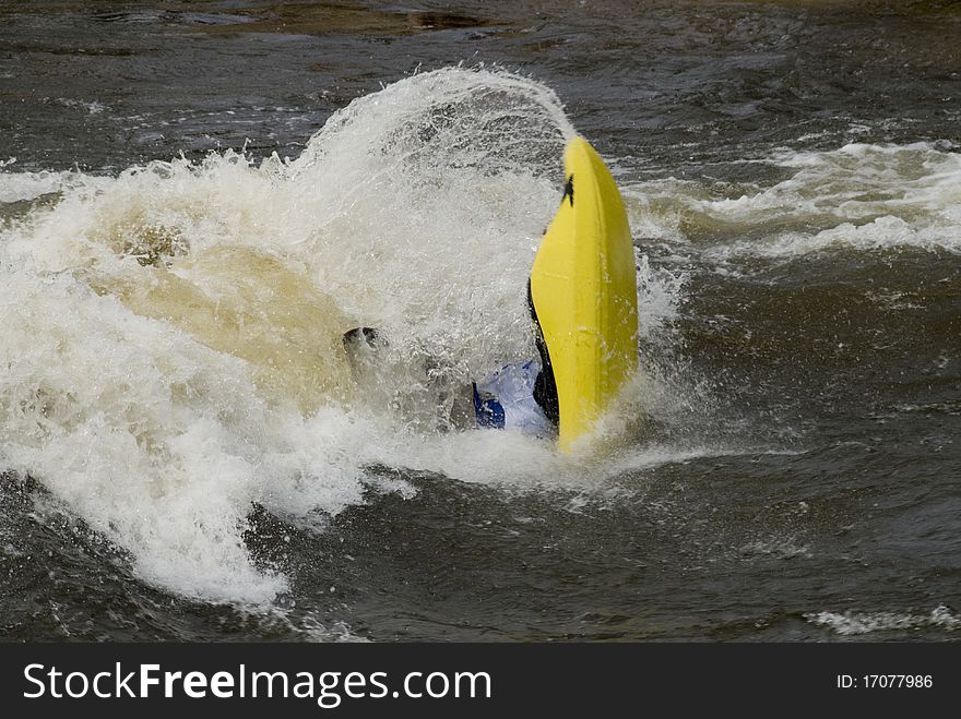 A freestyle kayaker navigates through river rapids in Steamboat Springs, Colorado