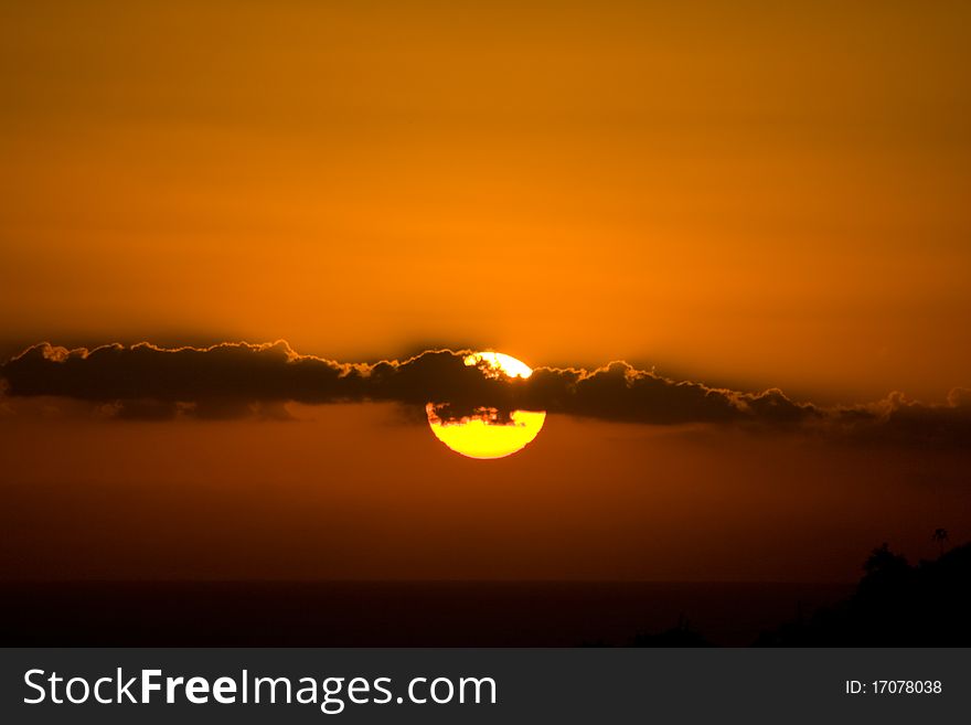 Sun close up behind clouds at sunset