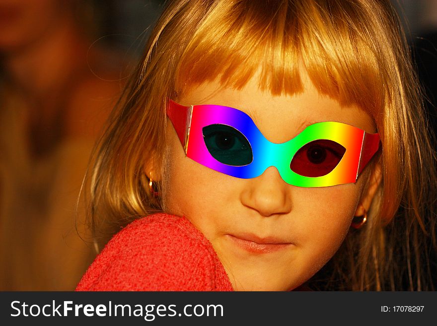 The image of golden-haired girl in a masquerade mask