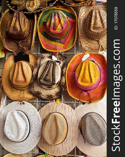 Souvenir hats hanging on the wall in a flea market