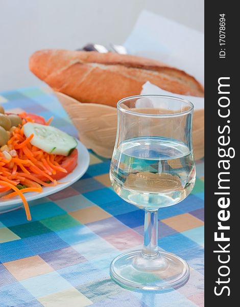 Still life with a salad and a glass of wine