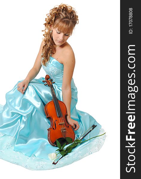 Female model with a violin and a white rose wearing a blue dress isolated on a white background. Female model with a violin and a white rose wearing a blue dress isolated on a white background