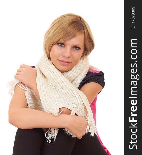 A close-up portrait of young blond women in knitted scarf. A close-up portrait of young blond women in knitted scarf