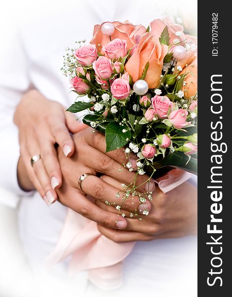 Wife and husband holding wedding bouquet. Wife and husband holding wedding bouquet
