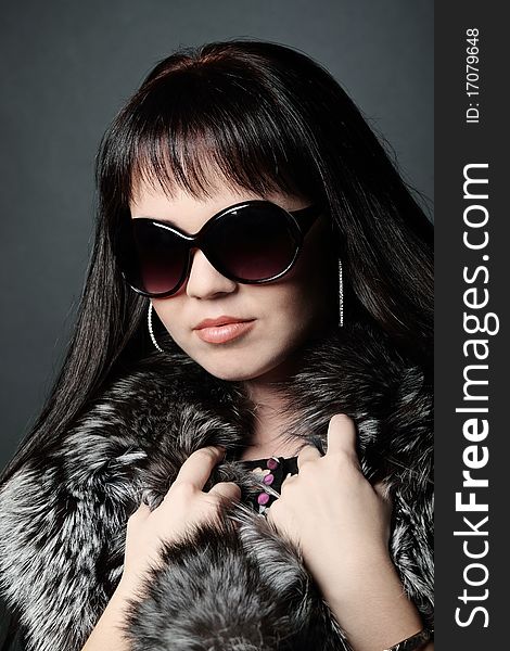 Fashion model girl in fur wearing sunglasses. Fashion model girl in fur wearing sunglasses