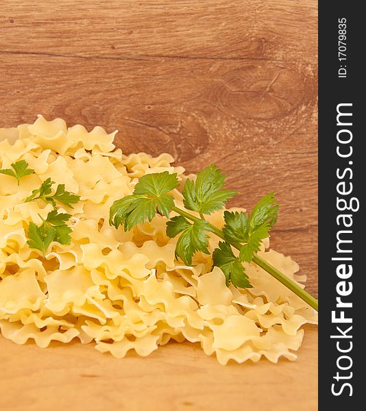 Pasta with green spice to a wooden board